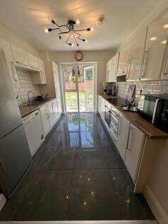 A bright and spacious kitchen featuring modern ...