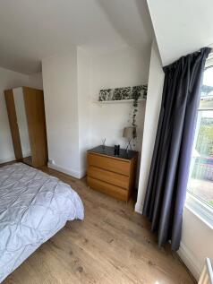 A spacious double bedroom featuring ample natur...