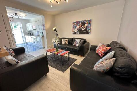 A stylish living room featuring comfortable bla...