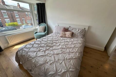 This inviting double bedroom features a cozy la...