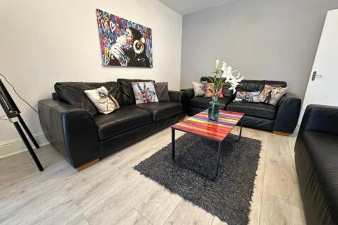 A stylish living room featuring comfortable bla...