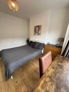 A cozy double bedroom featuring a comfortable b...