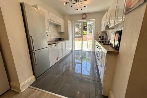A bright and spacious kitchen featuring modern ...