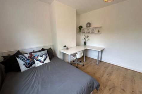 This inviting double bedroom features a cozy be...