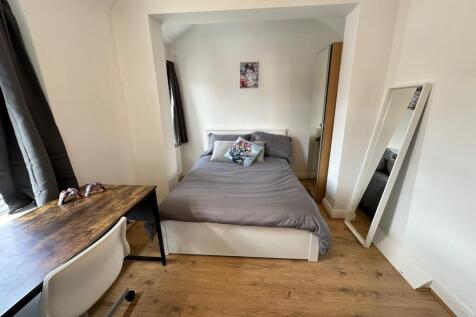 Cozy double bedroom featuring ample natural lig...