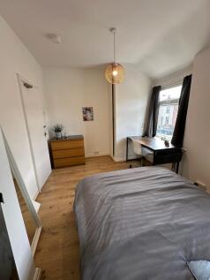 This inviting double bedroom features a cozy la...