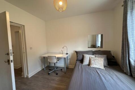 A beautifully designed double bedroom featuring...