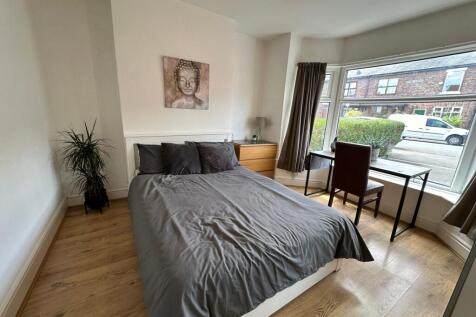 Bright and inviting double bedroom featuring la...