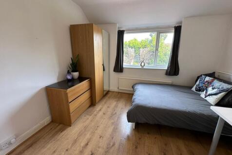A cozy double bedroom featuring stylish wooden ...