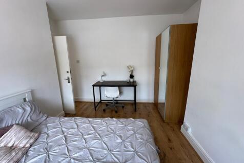 This inviting double bedroom features a comfort...