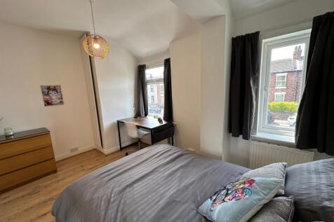 A beautifully styled double bedroom featuring a...