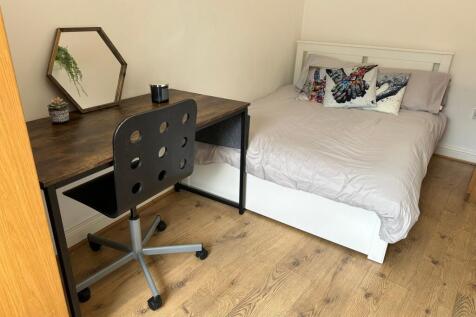 This inviting double bedroom features a comfort...