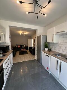 A modern kitchen featuring sleek cabinetry and ...