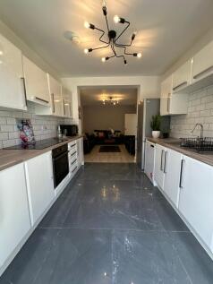 A modern kitchen featuring sleek cabinetry and ...
