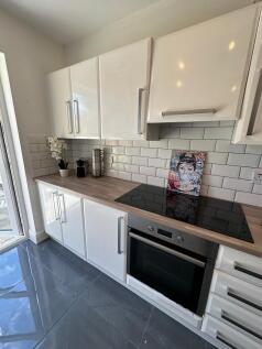 This modern kitchen features sleek cabinetry, a...