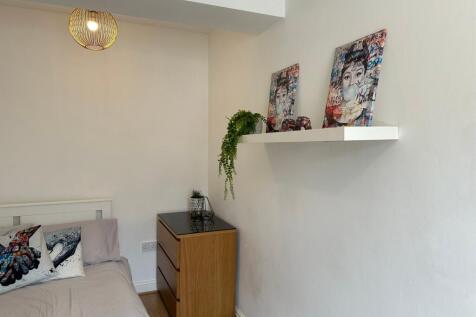 This cozy double bedroom features stylish decor...