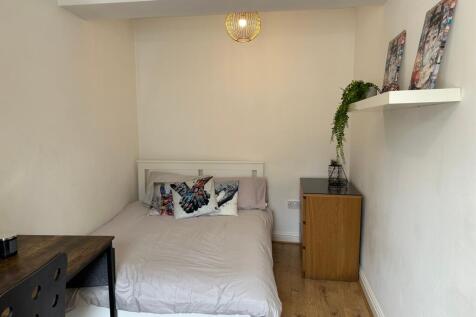 This cozy double bedroom features a comfortable...