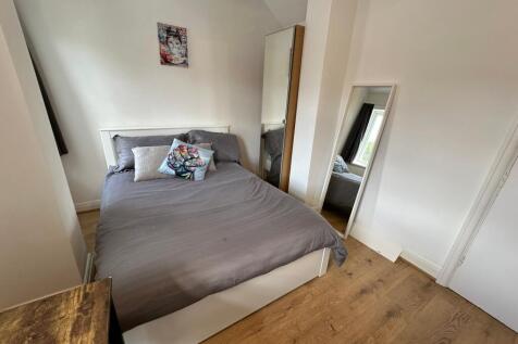 This inviting double bedroom features a comfort...