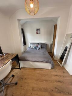 This cozy double bedroom features a comfortable...
