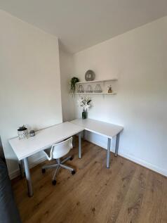 Bright and inviting communal workspace featurin...