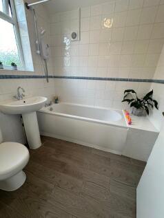 A bright and modern bathroom featuring a spacio...
