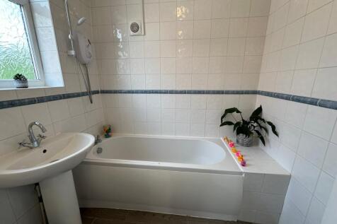A bright and modern bathroom featuring a spacio...