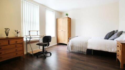 A spacious and inviting double bedroom featurin...