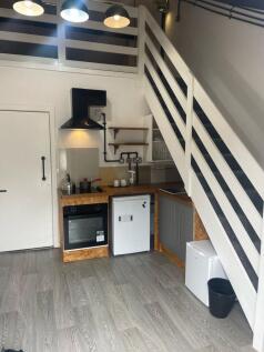 Charming kitchenette featuring modern appliance...