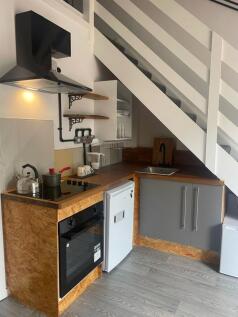This charming kitchenette offers a modern desig...