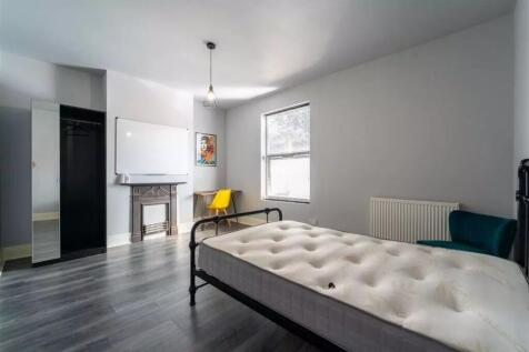 Spacious double bedroom featuring a stylish des...