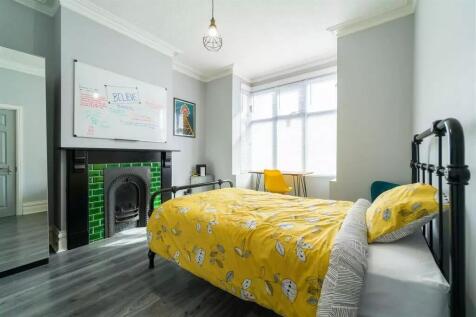 This inviting double bedroom features a cozy at...