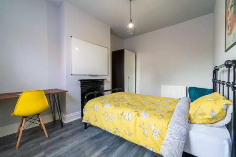 This charming double bedroom features a bright ...