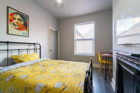 This charming double bedroom features a bright,...