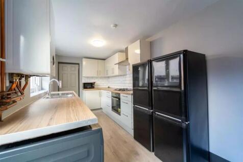 Modern kitchen featuring ample cabinetry, sleek...