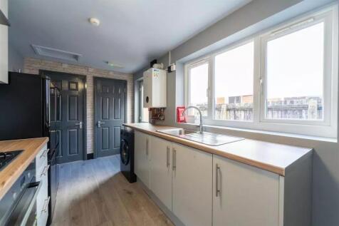 Modern kitchen featuring ample counter space, l...