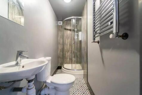 A modern bathroom featuring a sleek shower, sty...