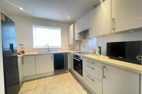 This modern kitchen boasts ample counter space ...