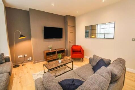 This contemporary living room features a cozy s...