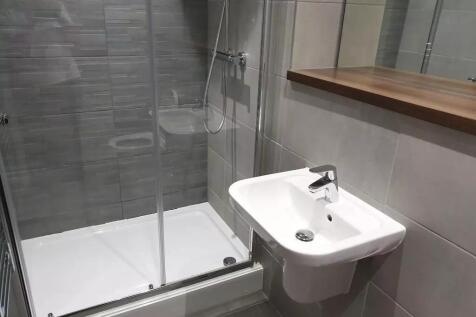 This modern bathroom features sleek tiles, a sp...