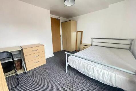 Spacious double bedroom featuring a comfortable...
