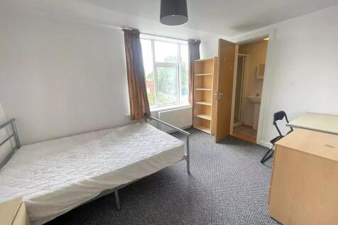 Spacious double bedroom featuring ample natural...