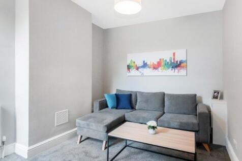 This stylish living room features a modern grey...