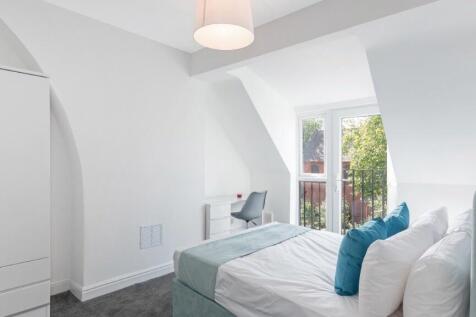 This inviting double bedroom features a comfort...
