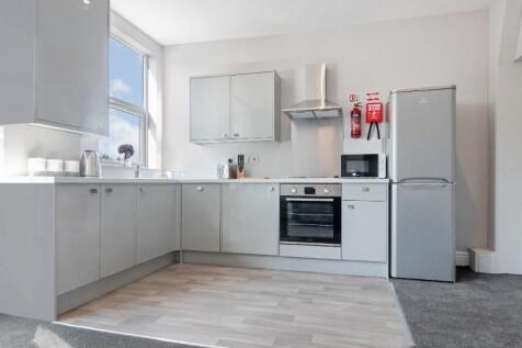 Bright and modern kitchen featuring sleek cabin...