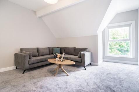 This inviting living room features a cozy gray ...