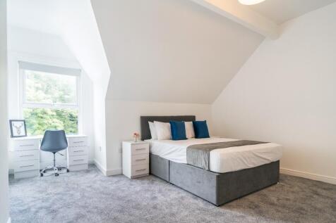Spacious double bedroom featuring a comfortable...