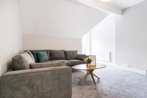 A contemporary living room featuring a cozy sec...