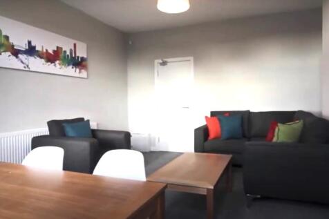 A bright and inviting living room featuring a c...