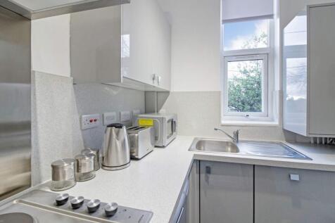 Charming kitchen featuring modern appliances an...