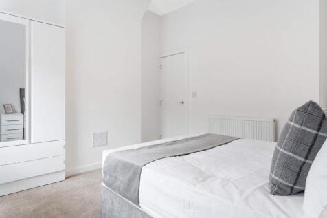 This inviting double bedroom features a comfort...